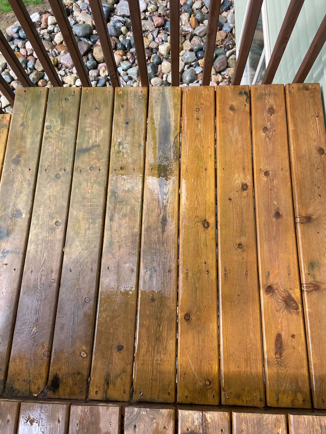 Before and after cleaning wooden deck boards, showing clean and stained areas.